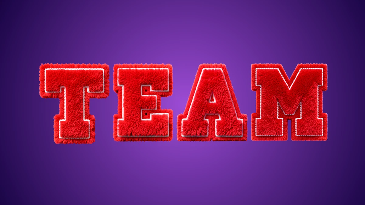 Fluffy 3D text from red fur with white stitching in a collegiate sport style